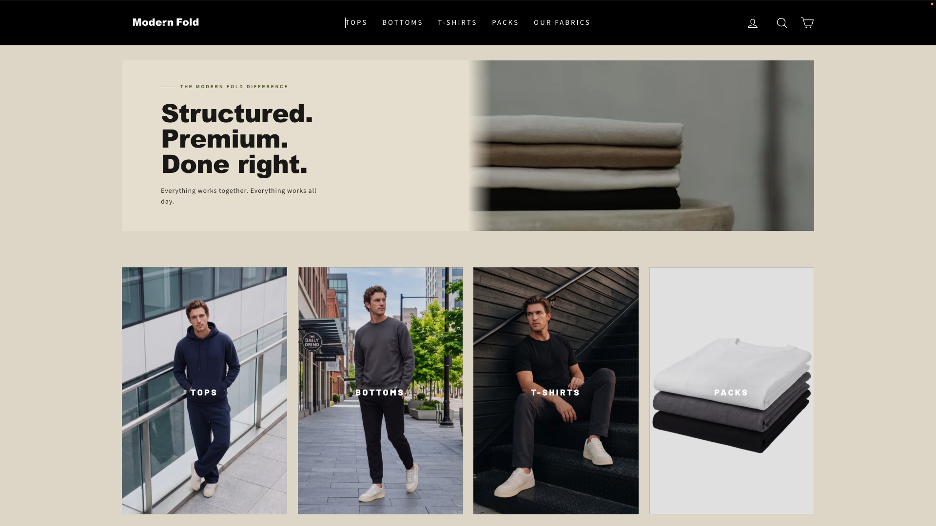 Homepage of Modern Fold clothing website featuring a header menu with categories: Tops, Bottoms, T-Shirts, Packs, Our Fabrics. Main section shows a large banner with folded clothes and bold text: 'Structured. Premium. Done right.' Below are images of male models in casual outfits representing categories: Tops, Bottoms, T-Shirts, Packs.