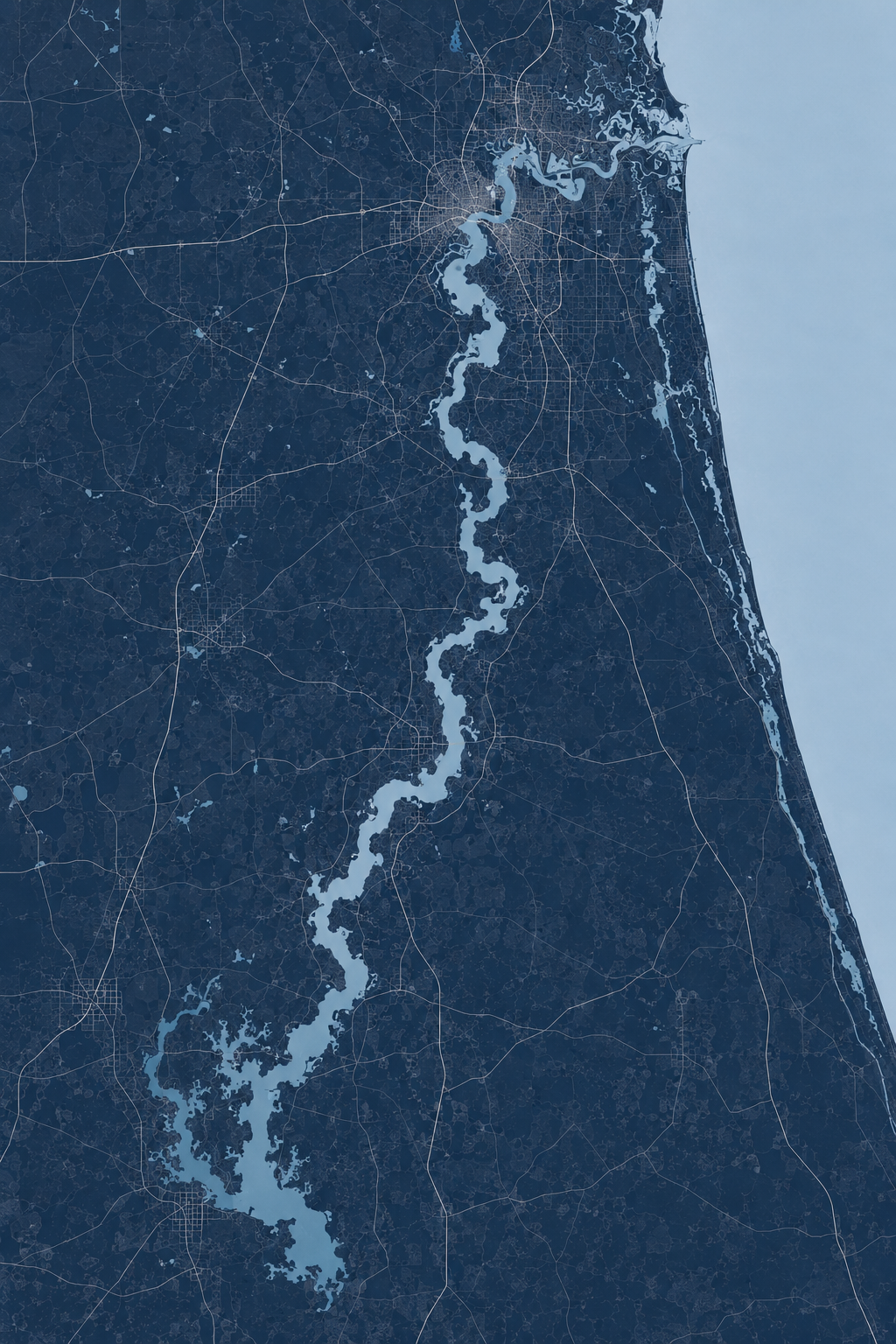 Map showing a winding river flowing from the bottom to the top of the image, with urban areas and roads surrounding it.