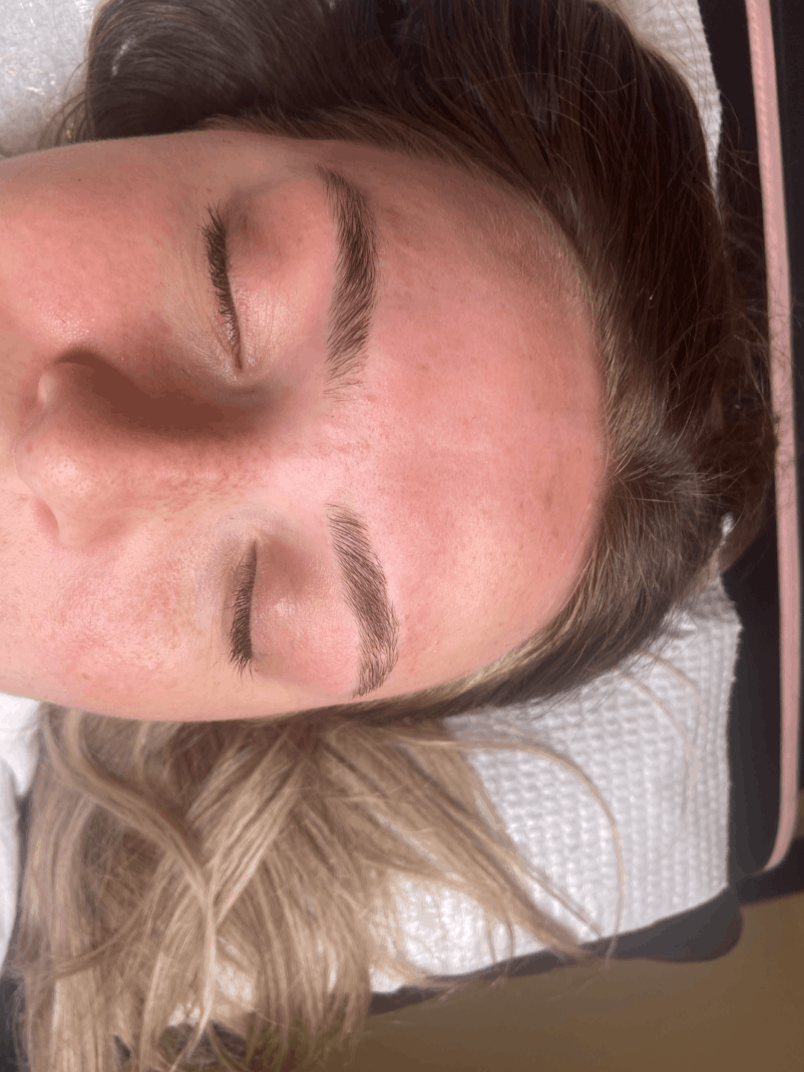 A woman with blonde hair lying down with her eyes closed, showing her smooth forehead and eyebrows.