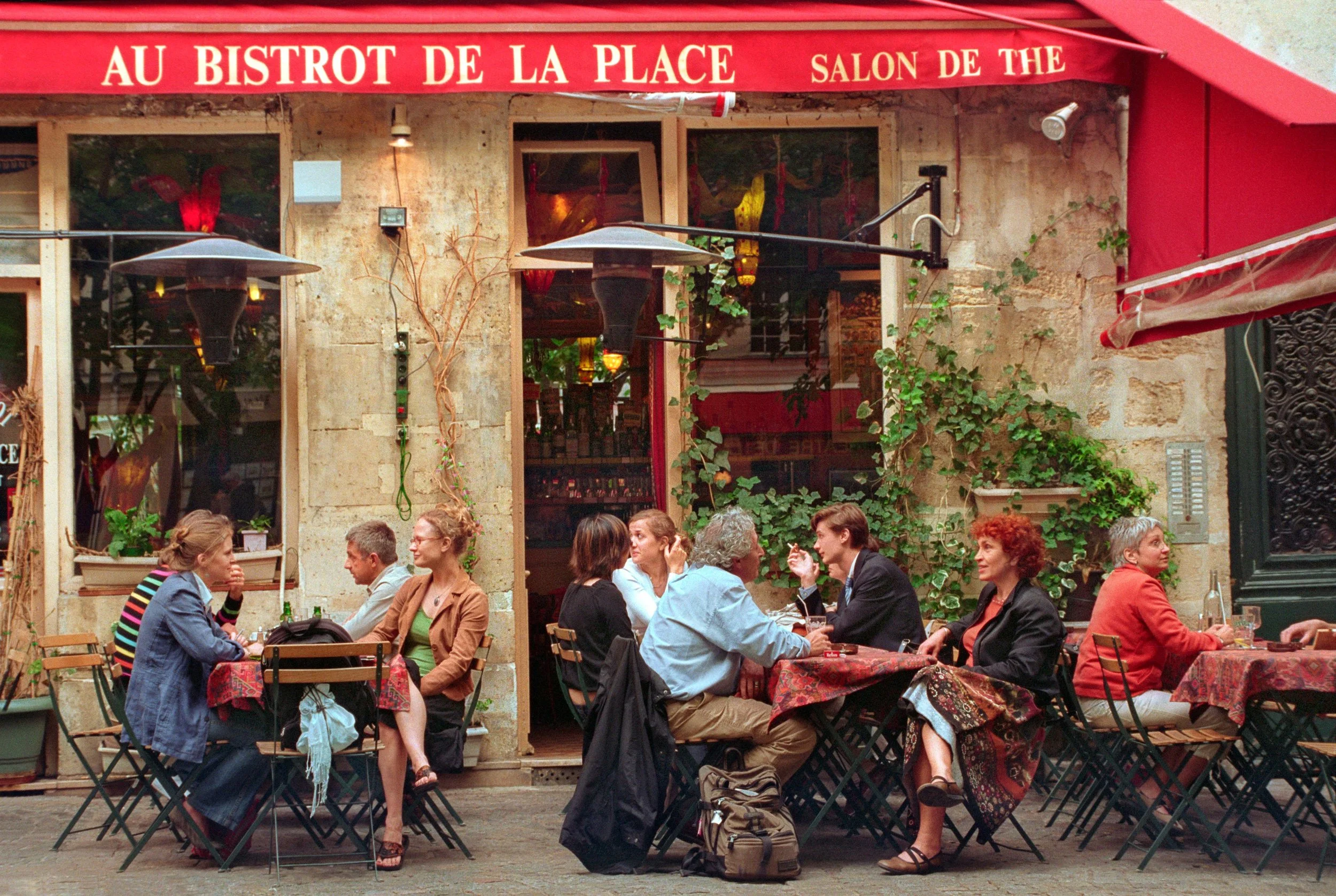 people sitting at a cafe in a french village