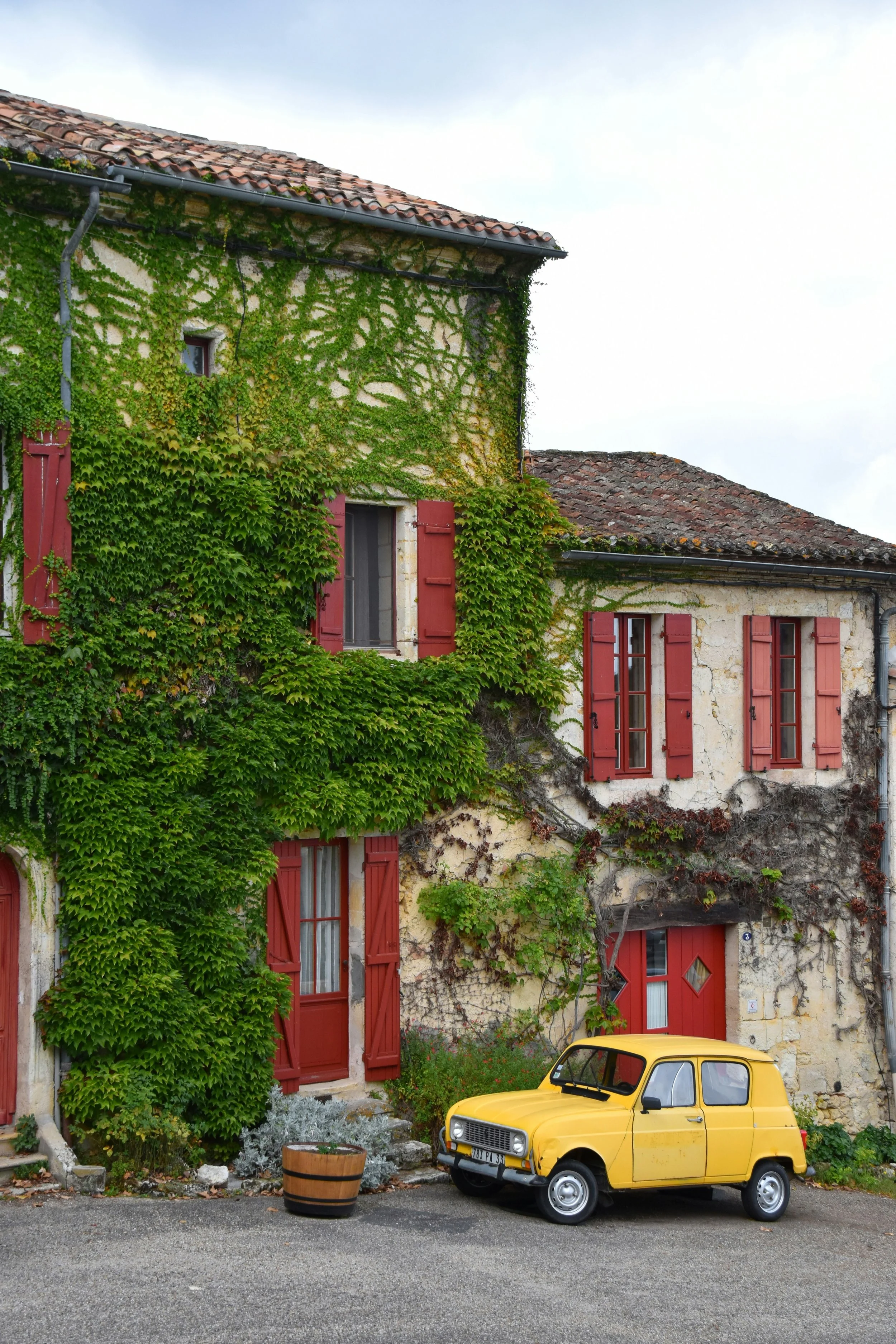 yellow car parked in front of a charming village home