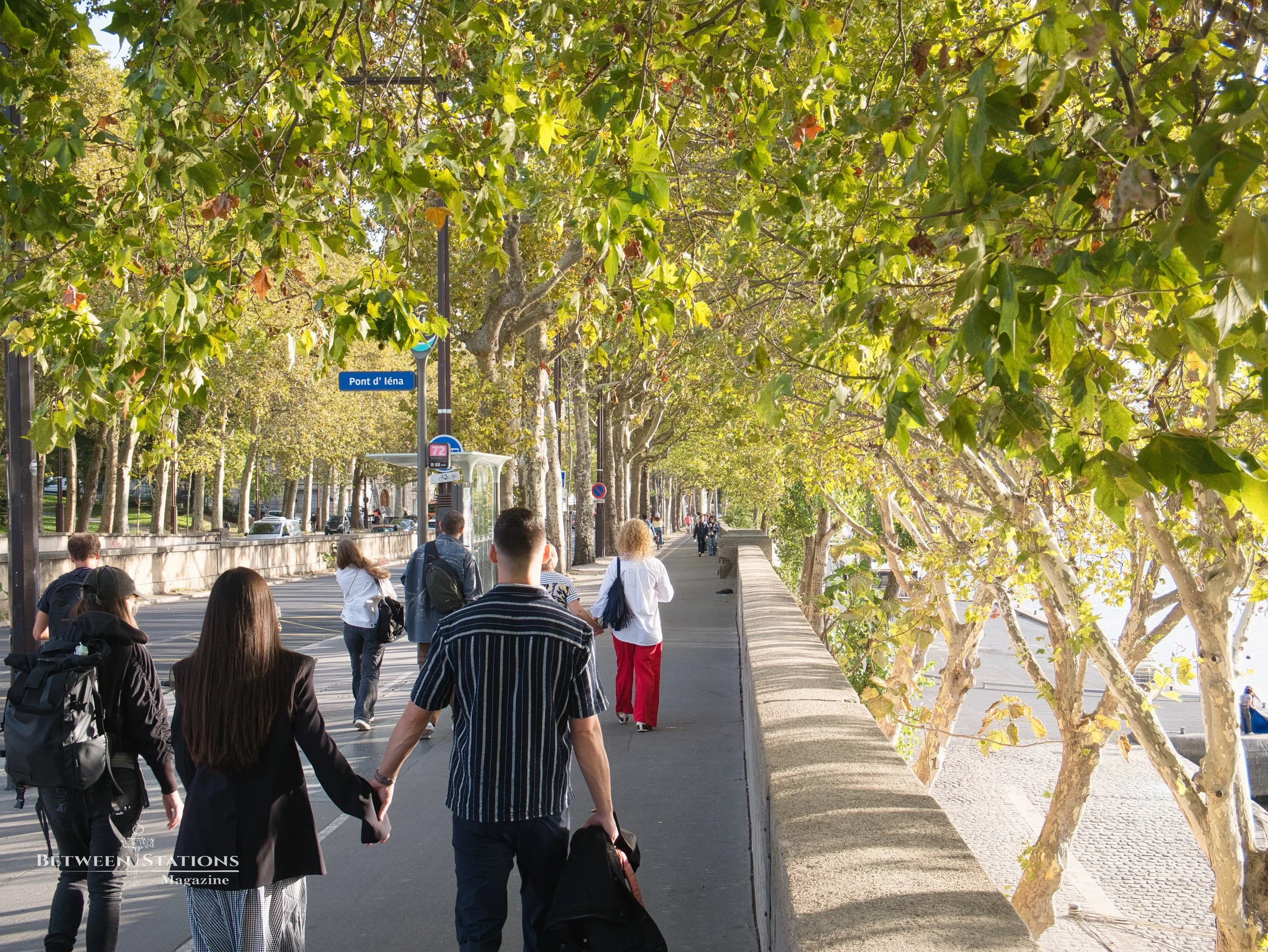 Couple walking hand in hand along the Pont d'Iéna promenade in Paris