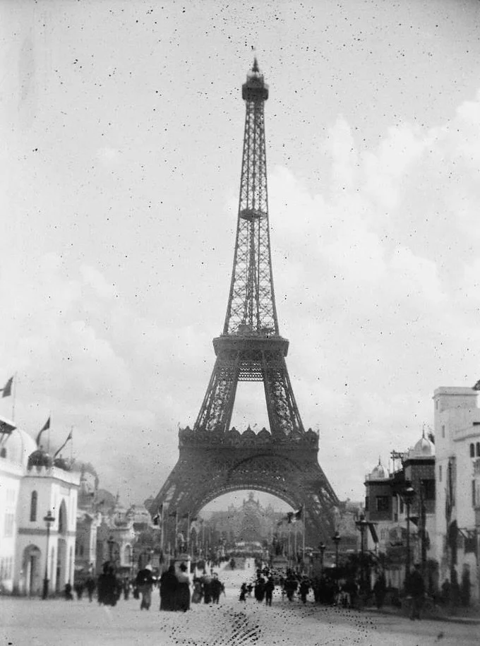 A rare archival view of the tower shortly after it opened for the 1889 Exposition Universelle, with fairgoers gathered beneath its arches.