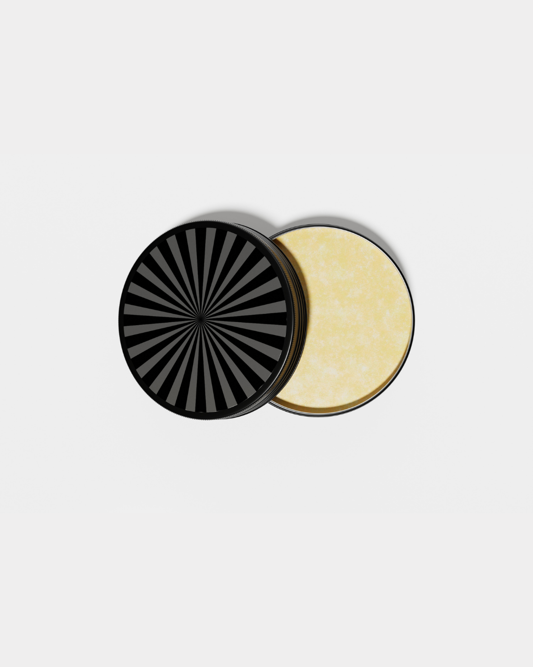 A round black container with a black and gray striped lid, partially opened to show yellowish contents inside.
