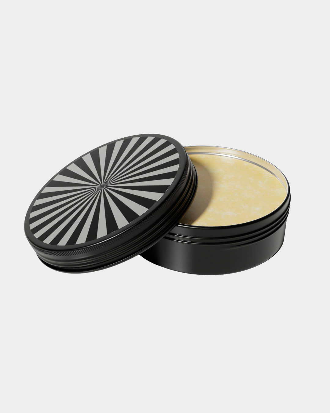Black round tin container with geometric black-and-white radial pattern on the lid, filled with yellowish substance.