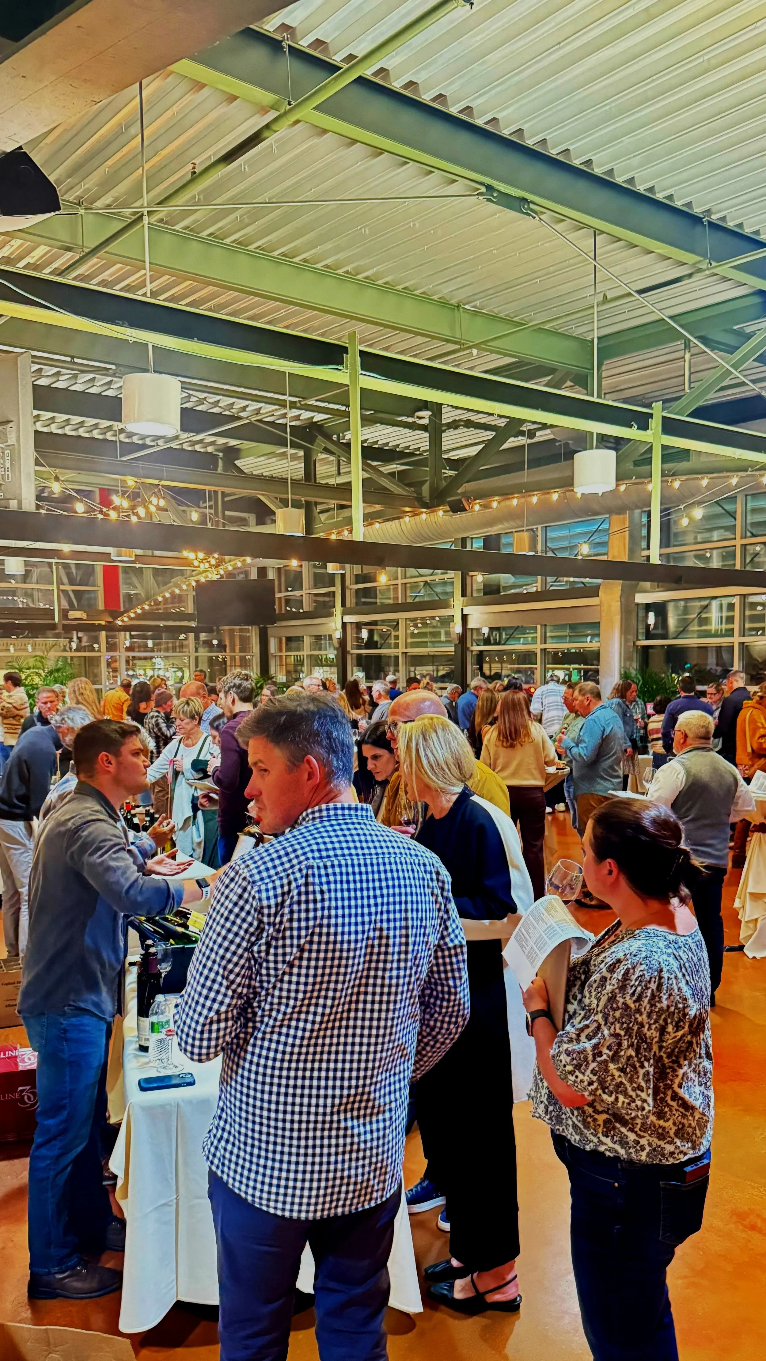 Crowd of people at Thief Wine Shop and Bar's Grand Tasting at the Milwaukee Public Market in the Historic Third Ward of Milwaukee, Wisconsin