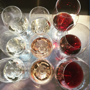 Several glasses of white, rosé, and red wine on a table at Thief Wine Shop and Bar in the Milwaukee Public Market in the Historic Third Ward of Milwaukee, Wisconsin.