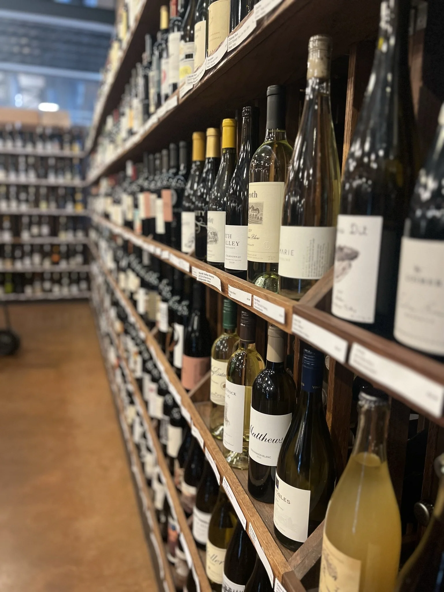 Shelves stocked with various bottles of white and red wine at Thief Wine Shop and Bar in the Milwaukee Public Market in the Historic Third Ward of Milwaukee, Wisconsin