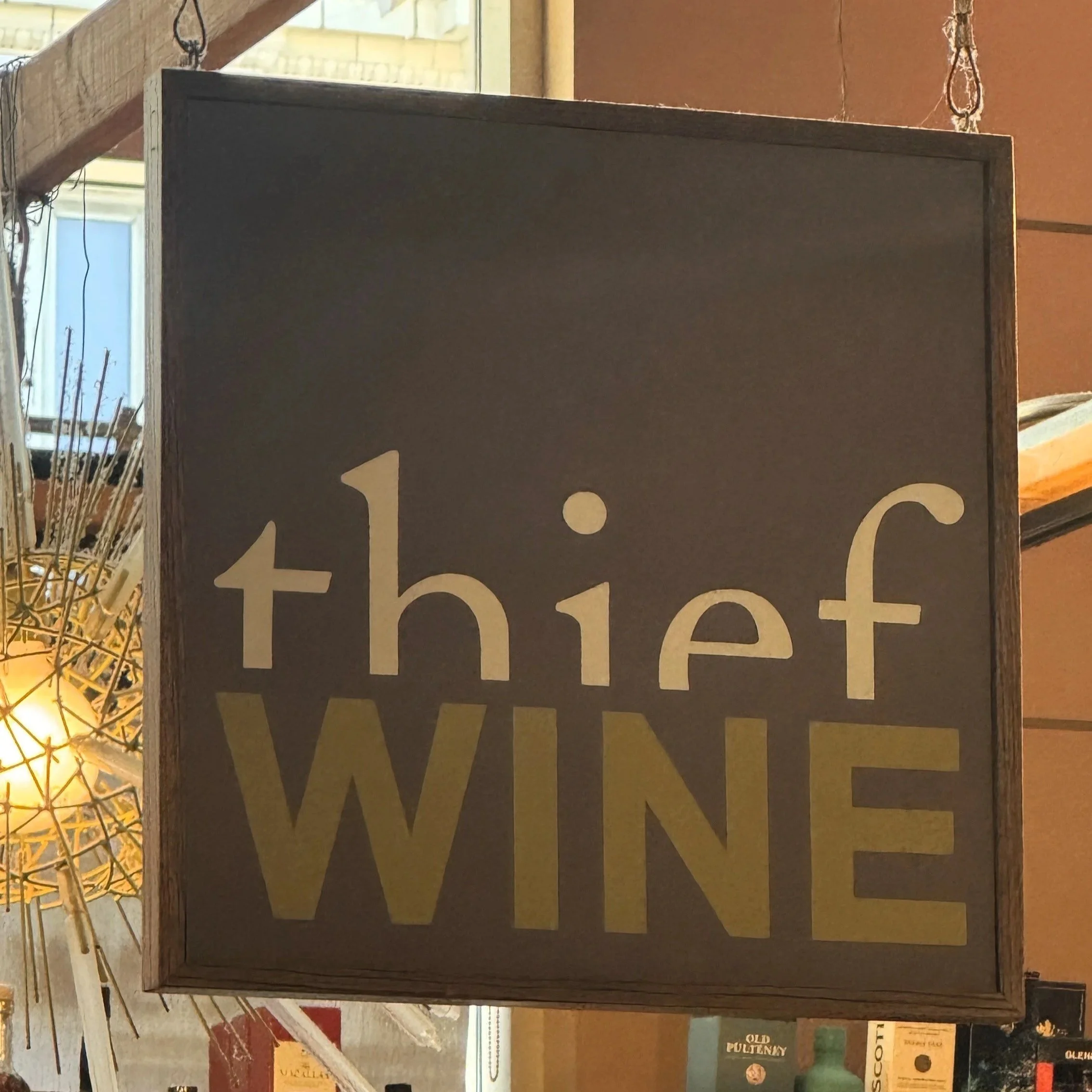 A hanging Thief Wine sign in the Milwaukee Public Market in the Historic Third Ward of Milwaukee, Wisconsin