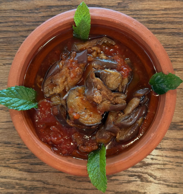 Freshly made Lebanese roasted eggplant dip in a traditional clay bowl at Shawbak in Melrose MA