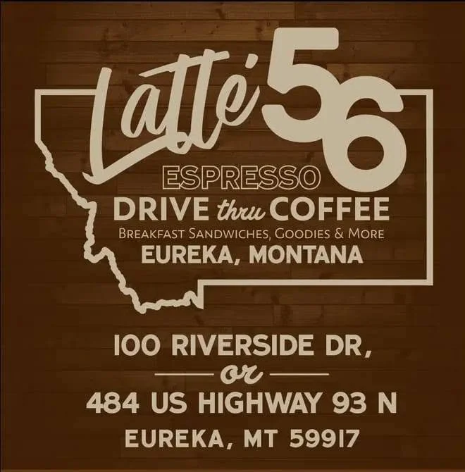 Sign for Latte 56 Espresso Drive-Thru Coffee in Eureka, Montana, with options for breakfast sandwiches and goodies, located at 100 Riverside Drive or 484 US Highway 93 North.