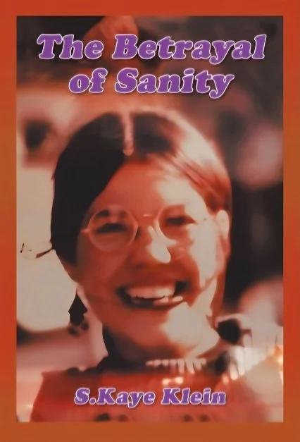 Book cover titled 'The Betrayal of Sanity' by S. Kaye Klein, featuring a woman with dark hair, glasses, and a wide smile.
