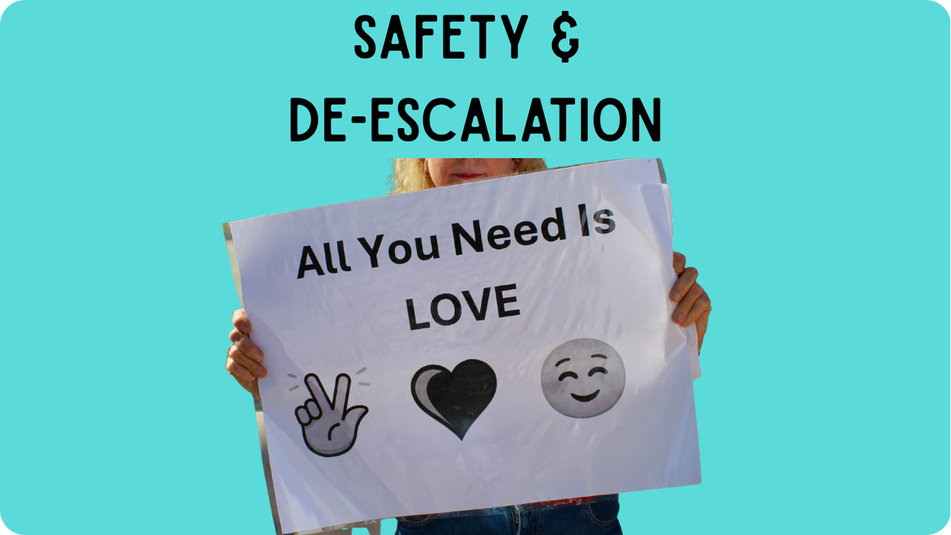 A protest sign with text all you need is love with an emoji of peace hands a heart and a smile