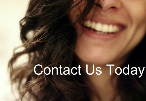 Close-up of a smiling woman with dark, curly hair and the text 'Contact Us Today' overlaid. - mobile dental hygiene clinic Salida CO