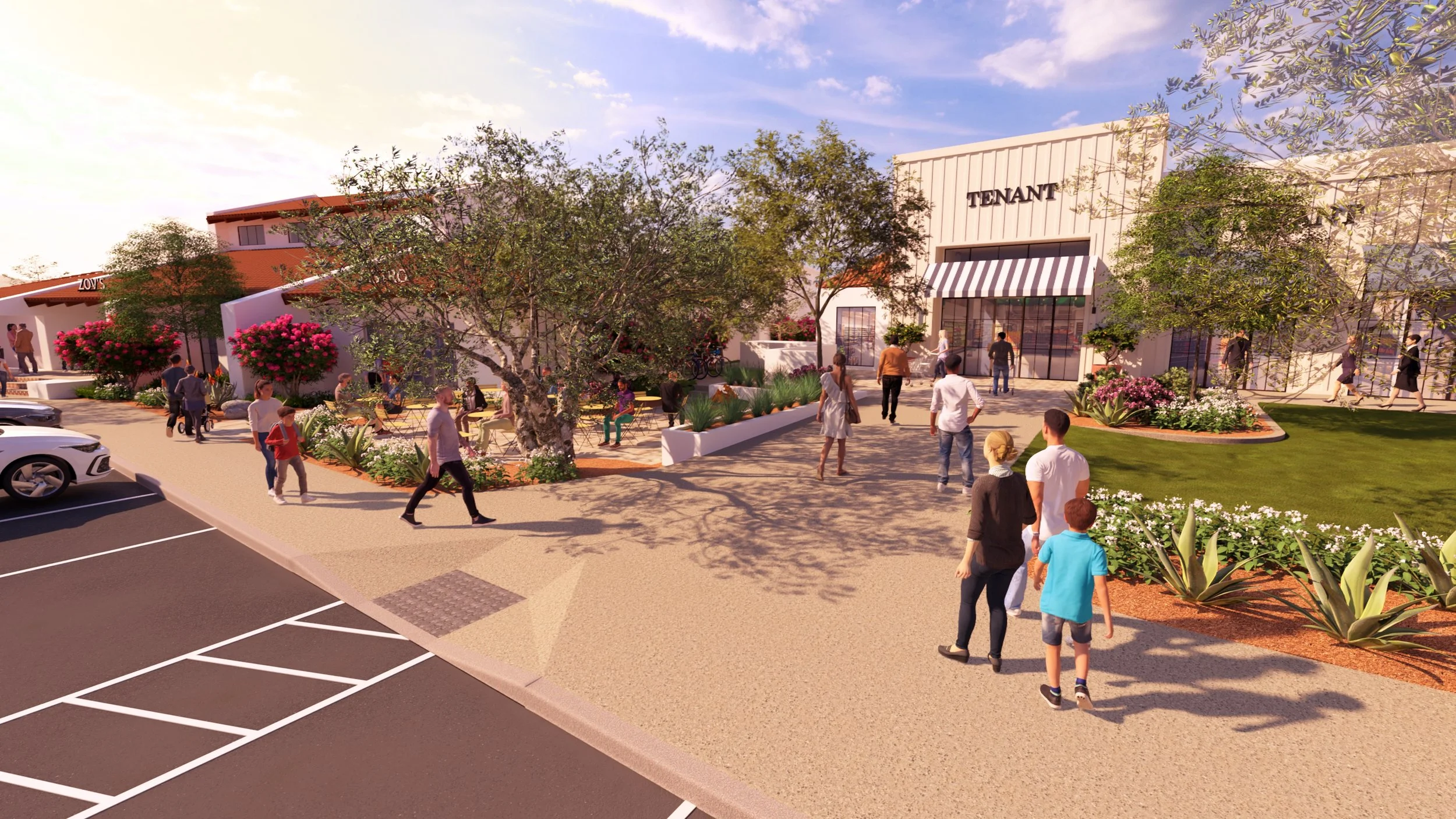 A shopping center with a tenant store, outdoor seating, people walking, and greenery including trees and flowers.