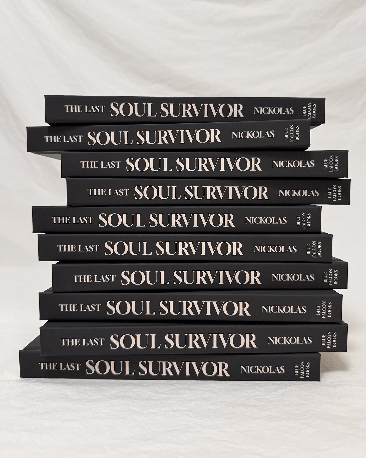 Stack of multiple black paperback books titled "The Last Soul Survivor" by Nickolas, published by Blue Falcon Books, arranged from top to bottom on a white surface against a white background.