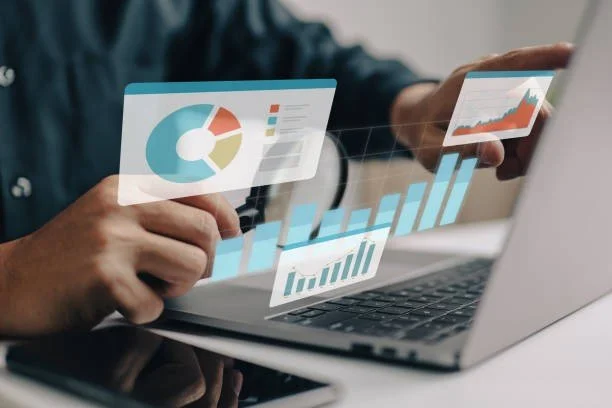 Person analyzing cost reduction results on a laptop and tablet.