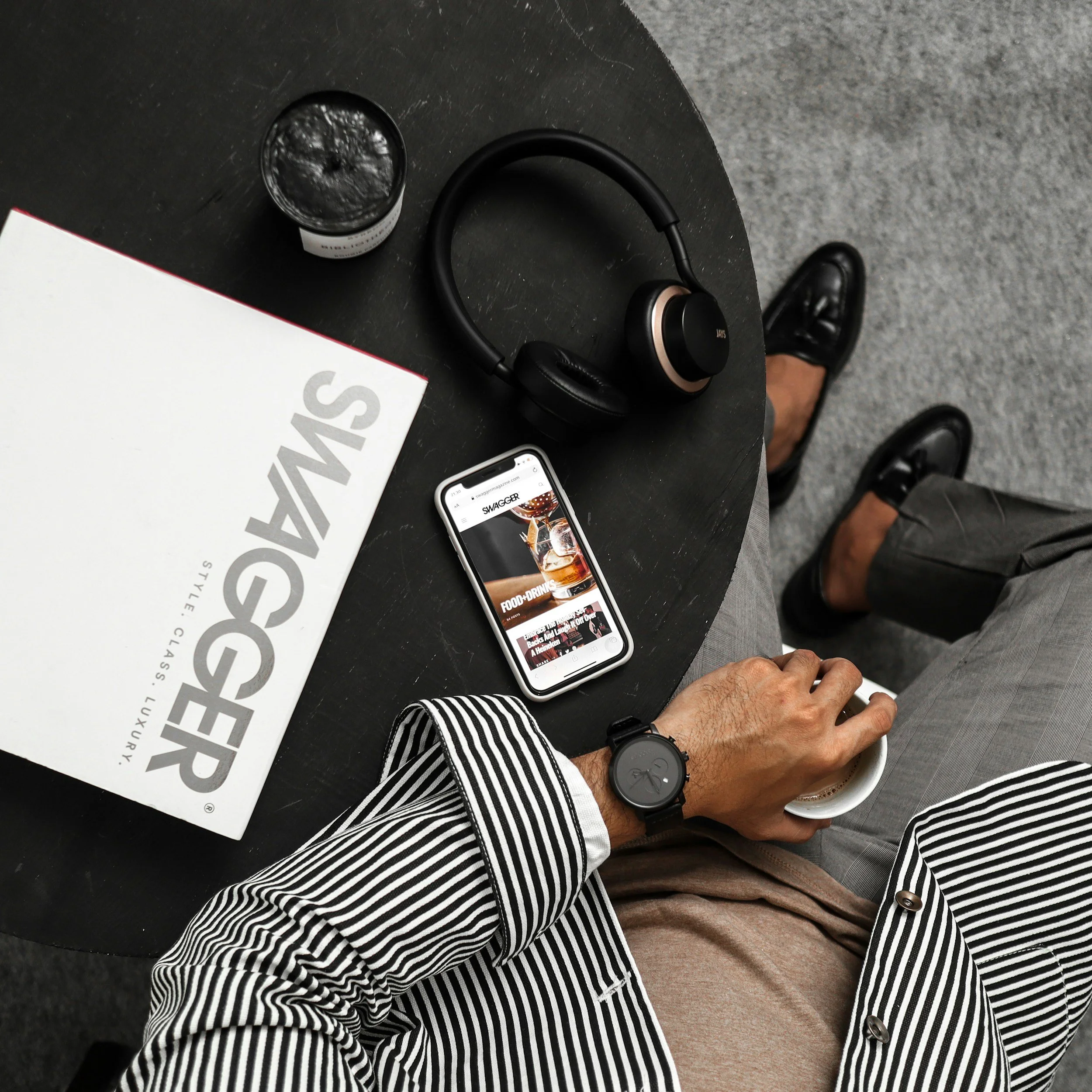 Confident, well-dressed sales professional with swagger sitting in a collaborative sales strategy session with digital tools supporting stronger sales performance.