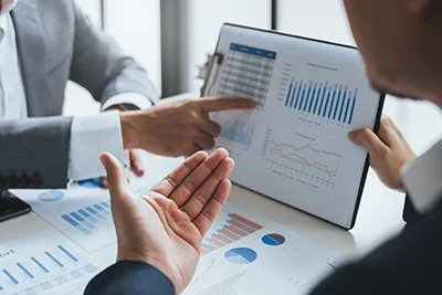 Business professionals discussing the results of a cost reduction analysis.
