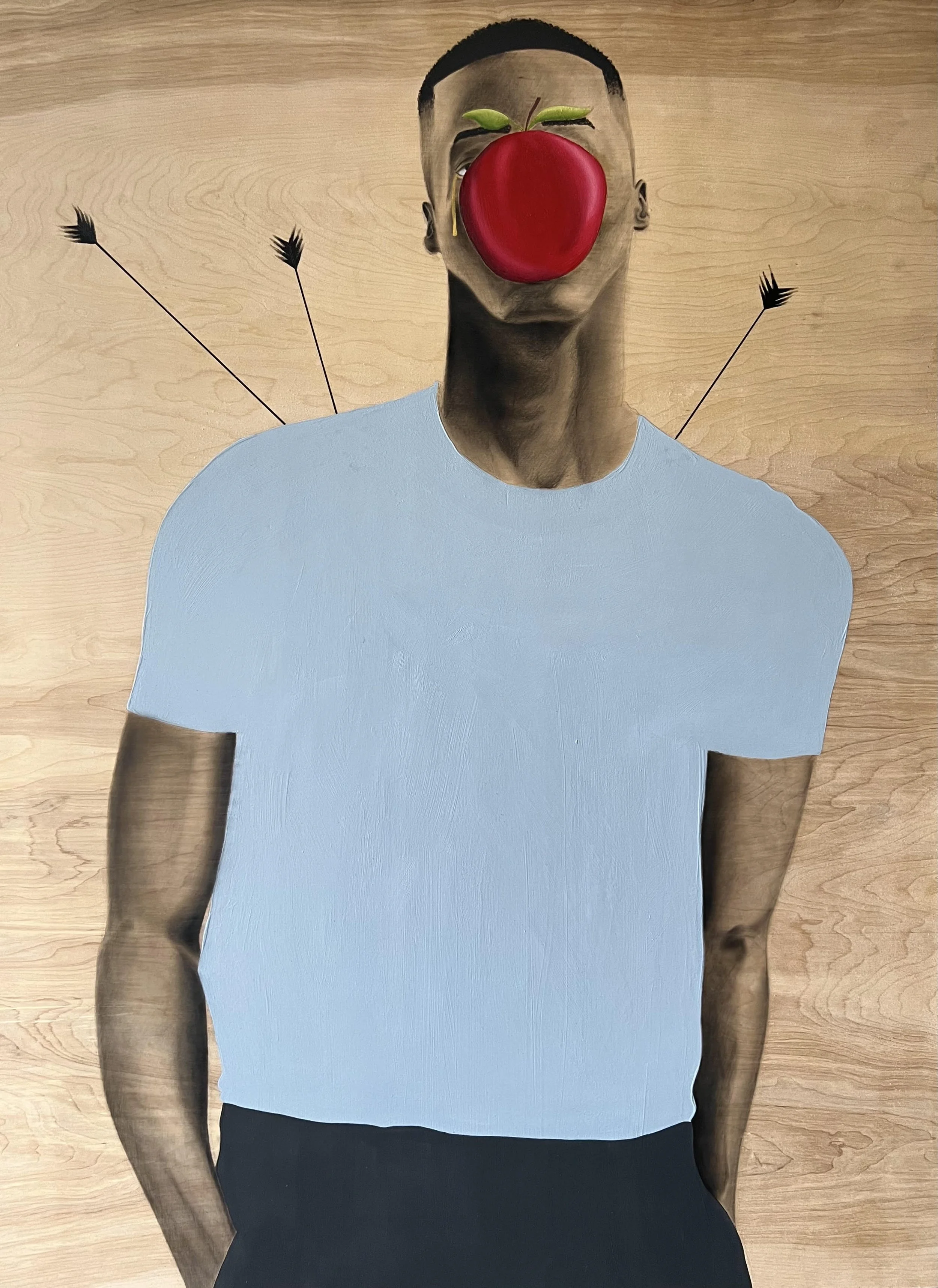 A person wearing a blue t-shirt and dark pants stands against a wooden floor background, with a red apple and green leaves overlaid on their face in the image.