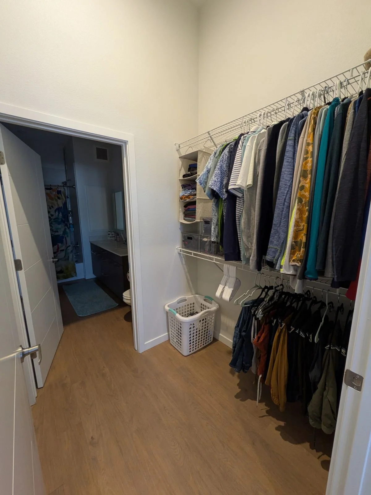 BEFORE…Now client can see and access his clothes with a clear path through to the bathroom.