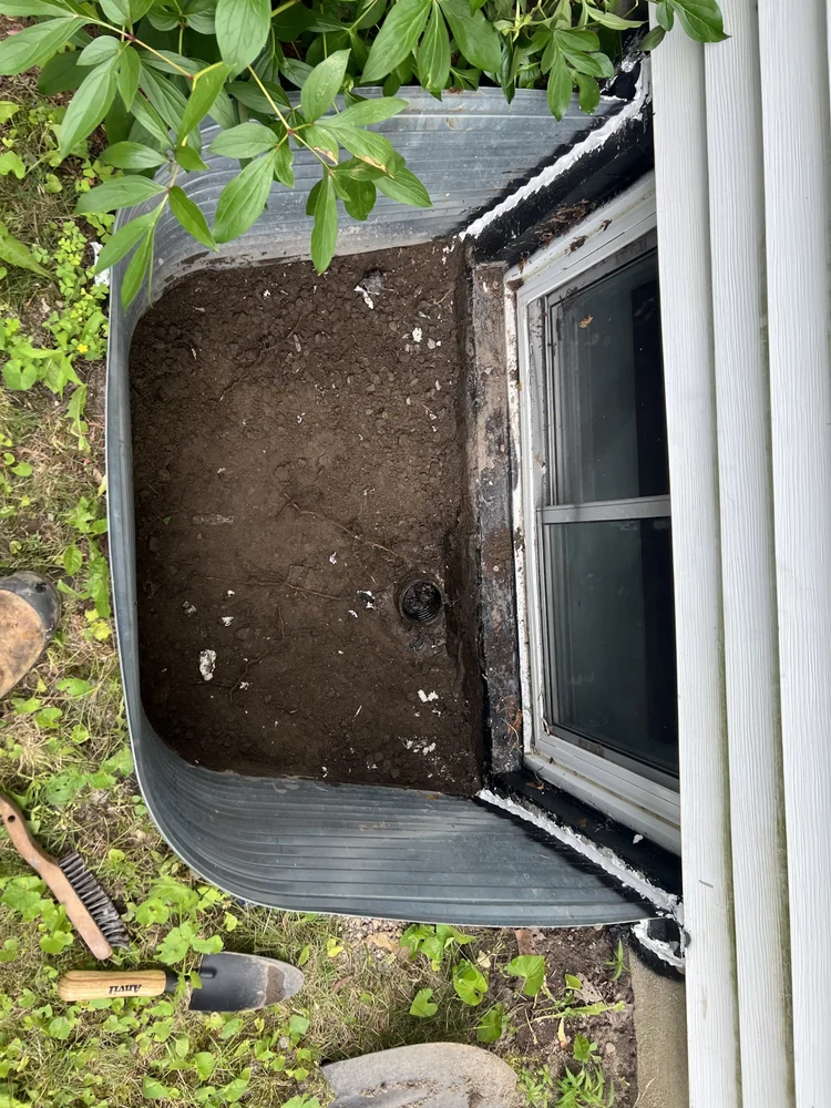 Excavating and testing the window well drain pipe