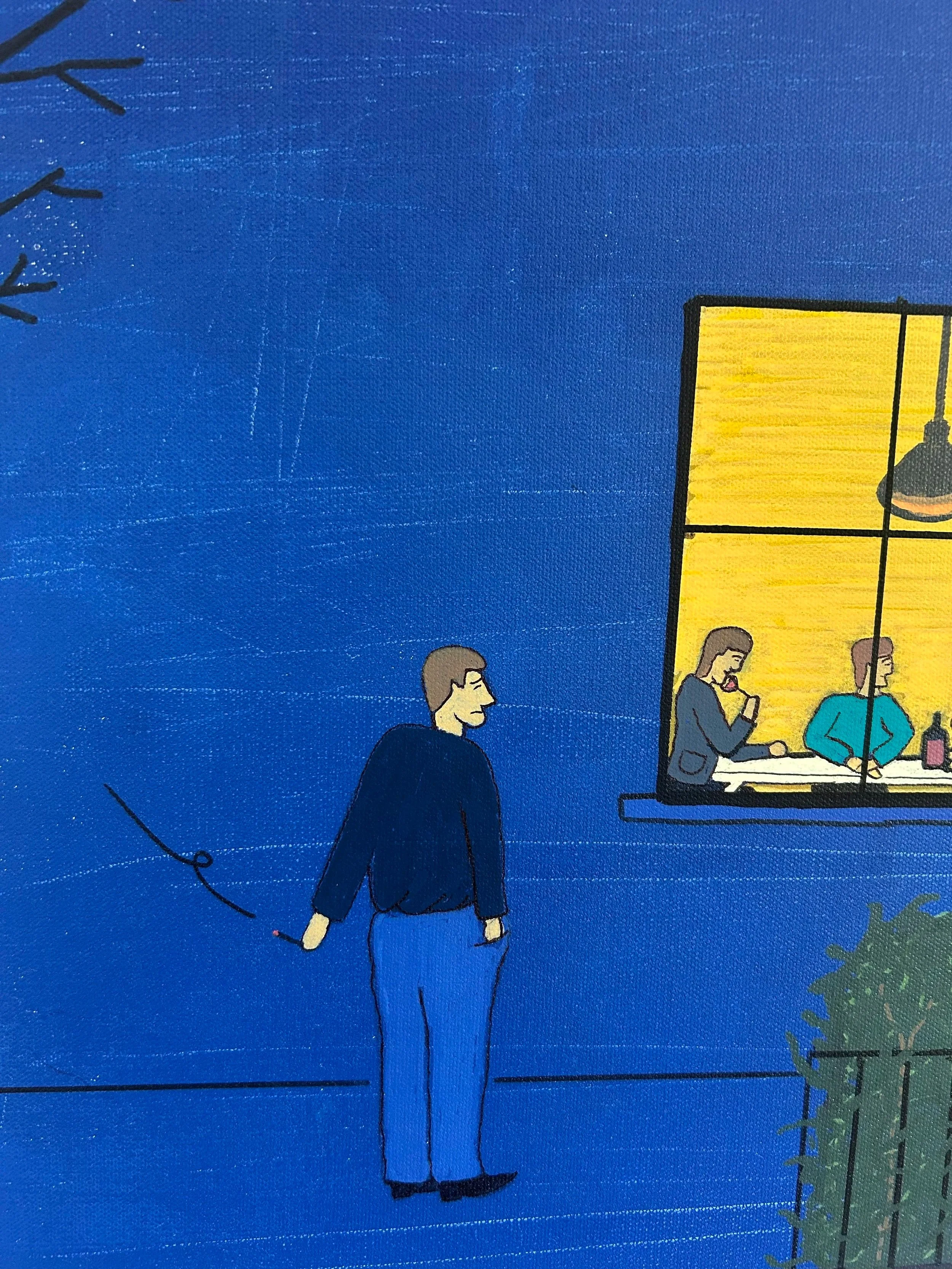A man stands outside a lit apartment window watching strangers share dinner together.