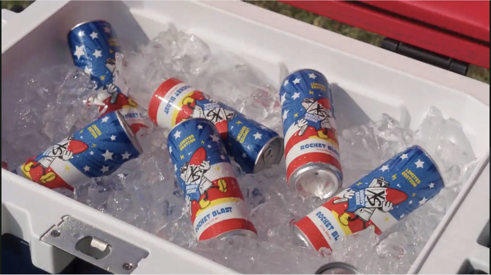 A cooler filled with ice and several cans of Rocket Blaster soda with patriotic space-themed graphics.