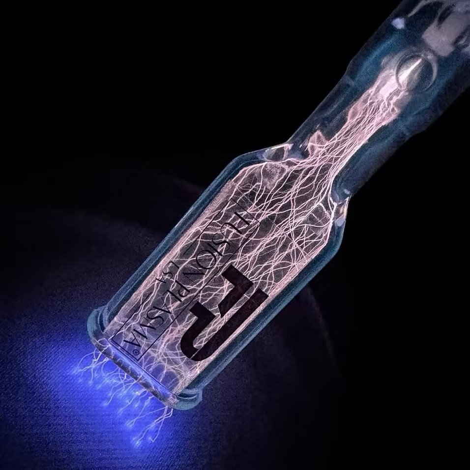 Fusion Plasma technology showing a visible plasma discharge used in Skin Intrinsic treatments.