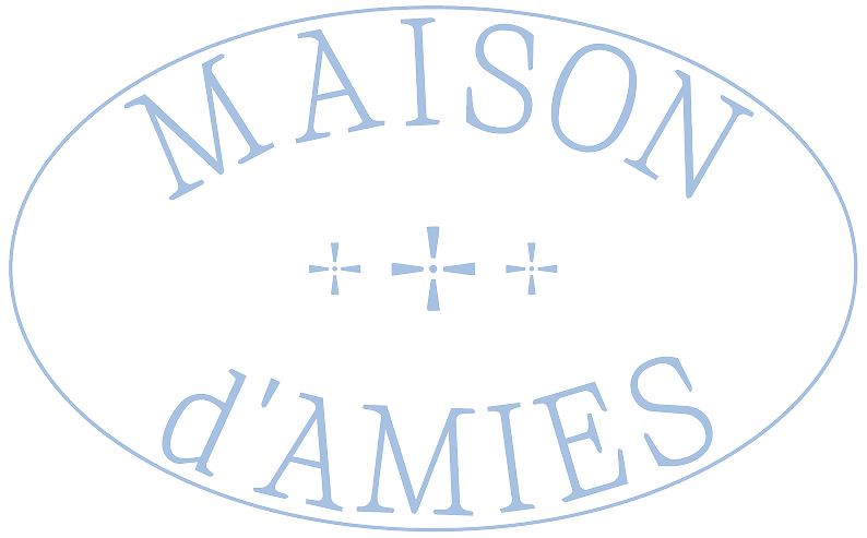 Logo with the words "MASON d'AMES" in a curved line inside an oval shape with three plus signs in the center.