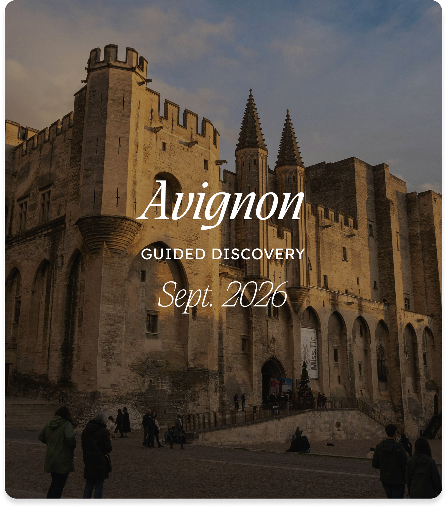 Photo of a historic castle with towers and battlements, taken at dusk. People are walking in front of the castle, and the sky is partly cloudy. Text overlay on the image reads: 'Avignon Guided Discovery Sept. 2026'.