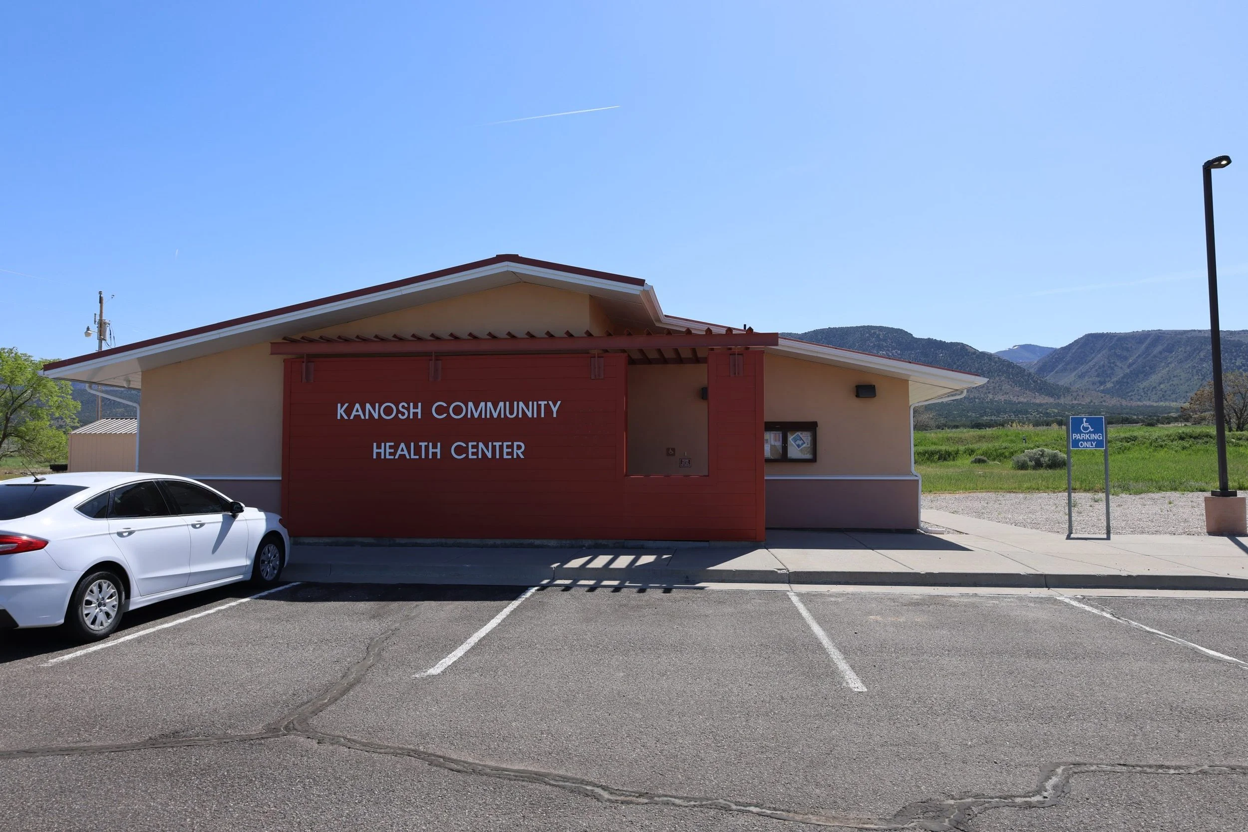 Kanosh Community Health Center building with accessible parking and mountains in the background