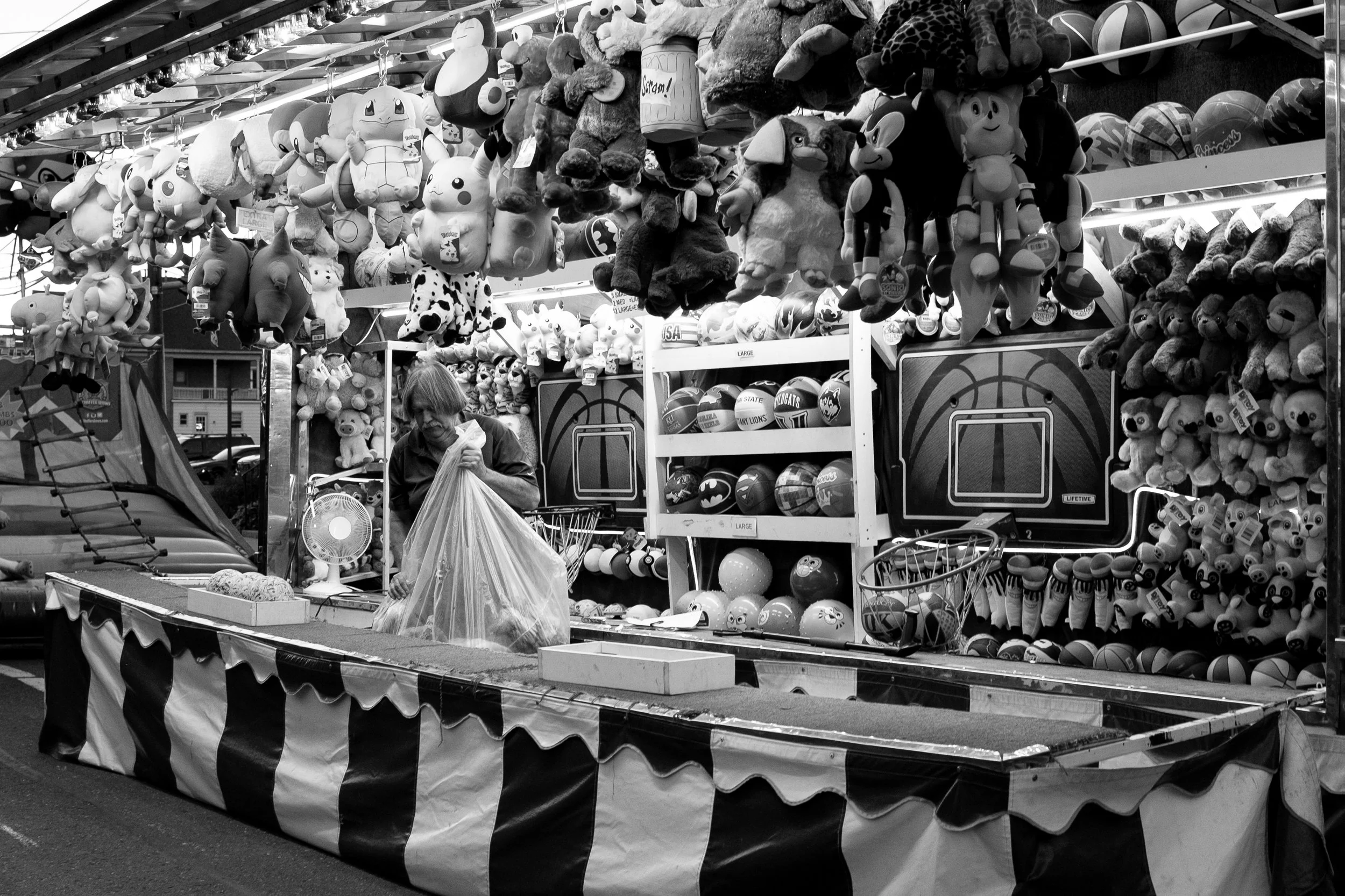 Worker restocks his stand at the New Holland county fair in New Holland Pa. on Oct. 4, 2025.