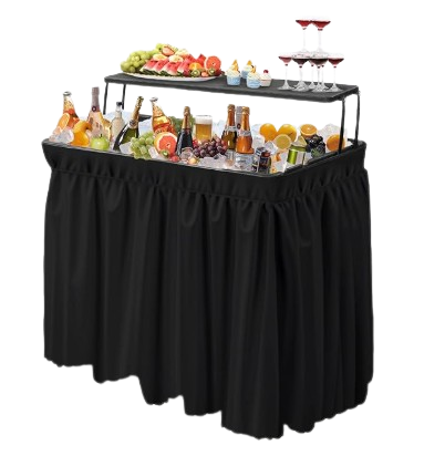 A buffet table with a black skirt, featuring a glass display with various beverages, fruits, and small bottles.