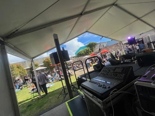 Front-of-house console overlooking an outdoor festival stage