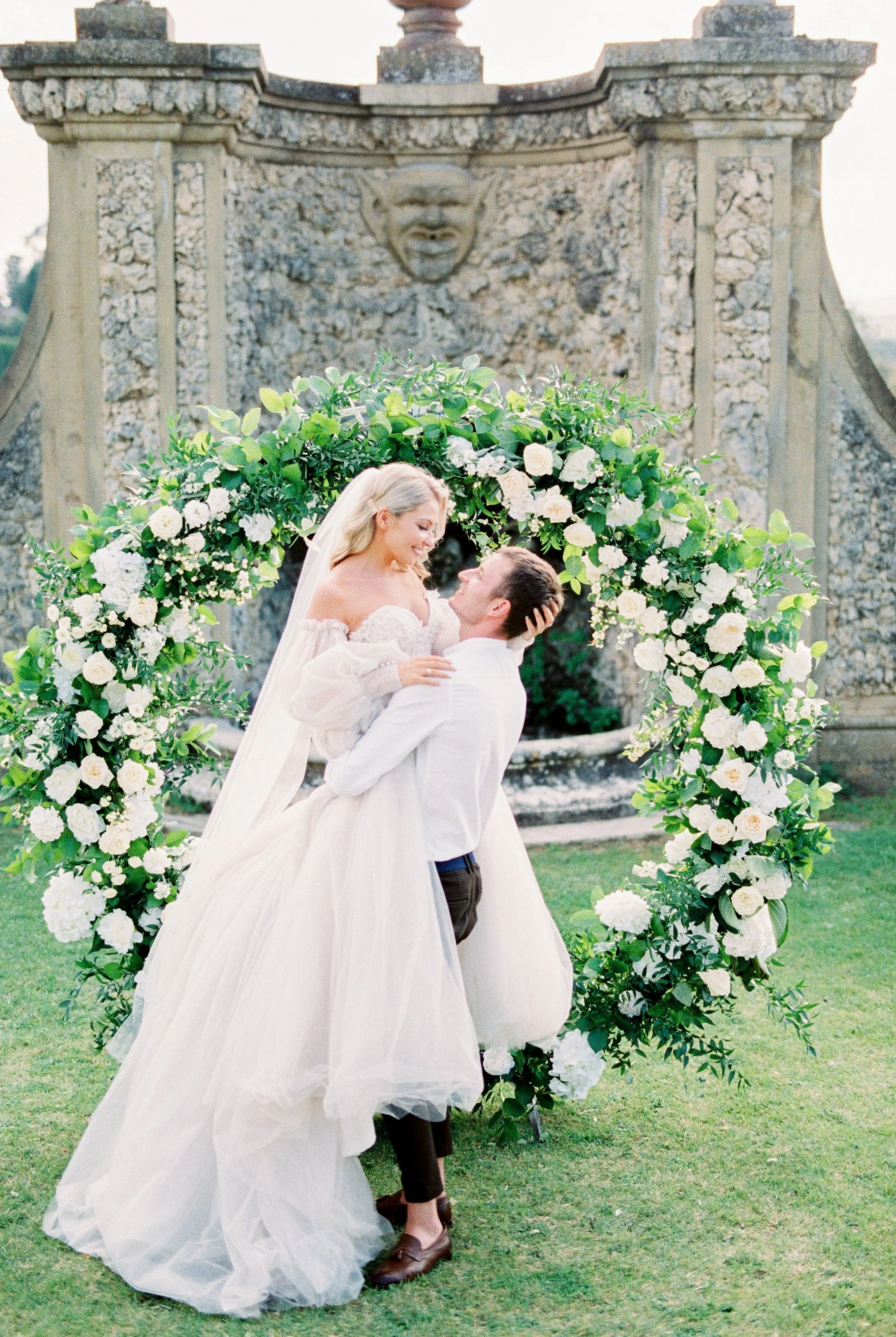 groom-holds-bride-in-his-arms-at-the-wedding-arch-2026-01-07-02-11-12-utc.jpg