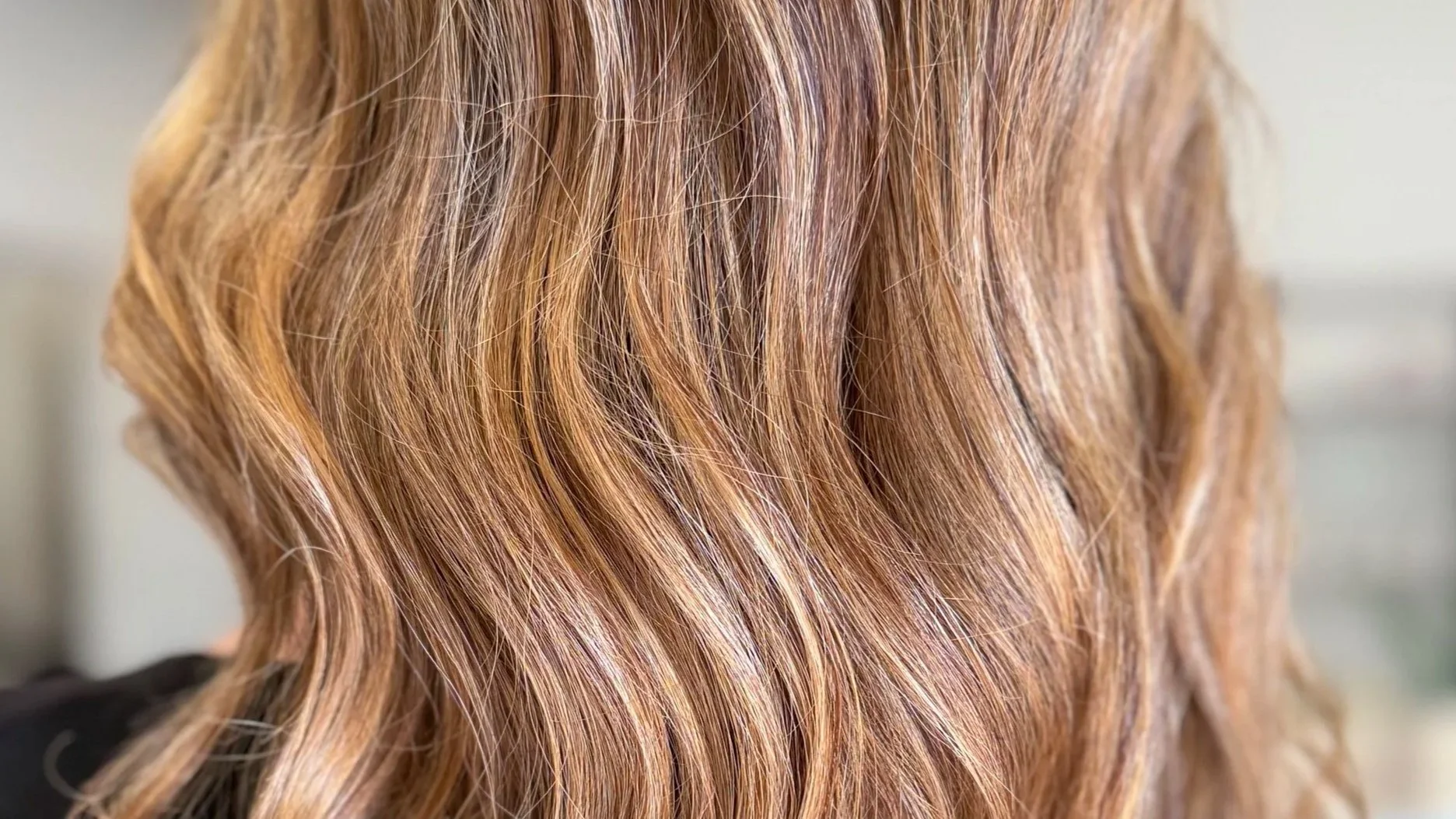 Close-up of wavy, reddish-blonde hair.
