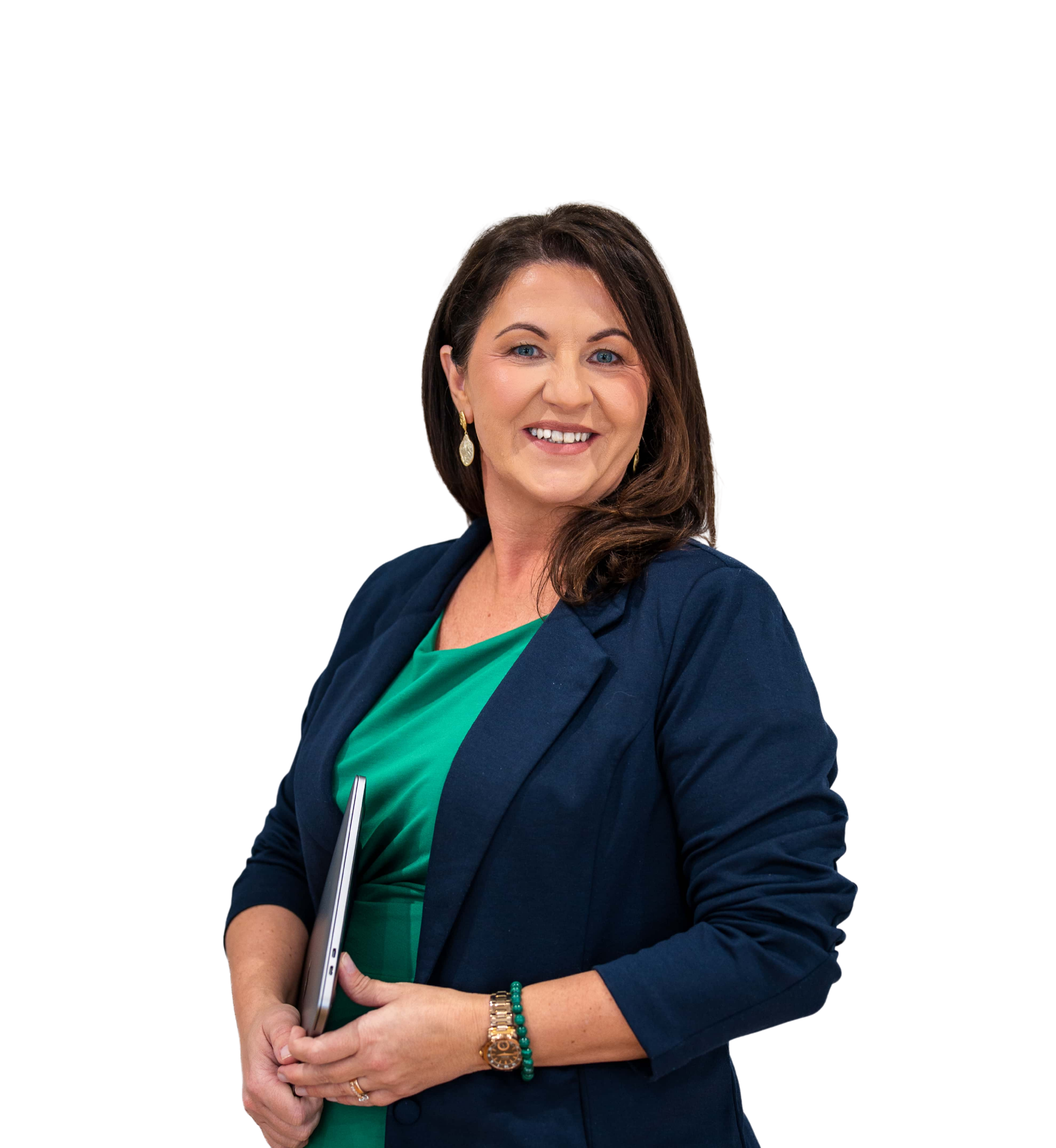 Magda Campbell, wearing a teal blouse and a navy blazer, holding a silver laptop and a pen, standing against a black background.