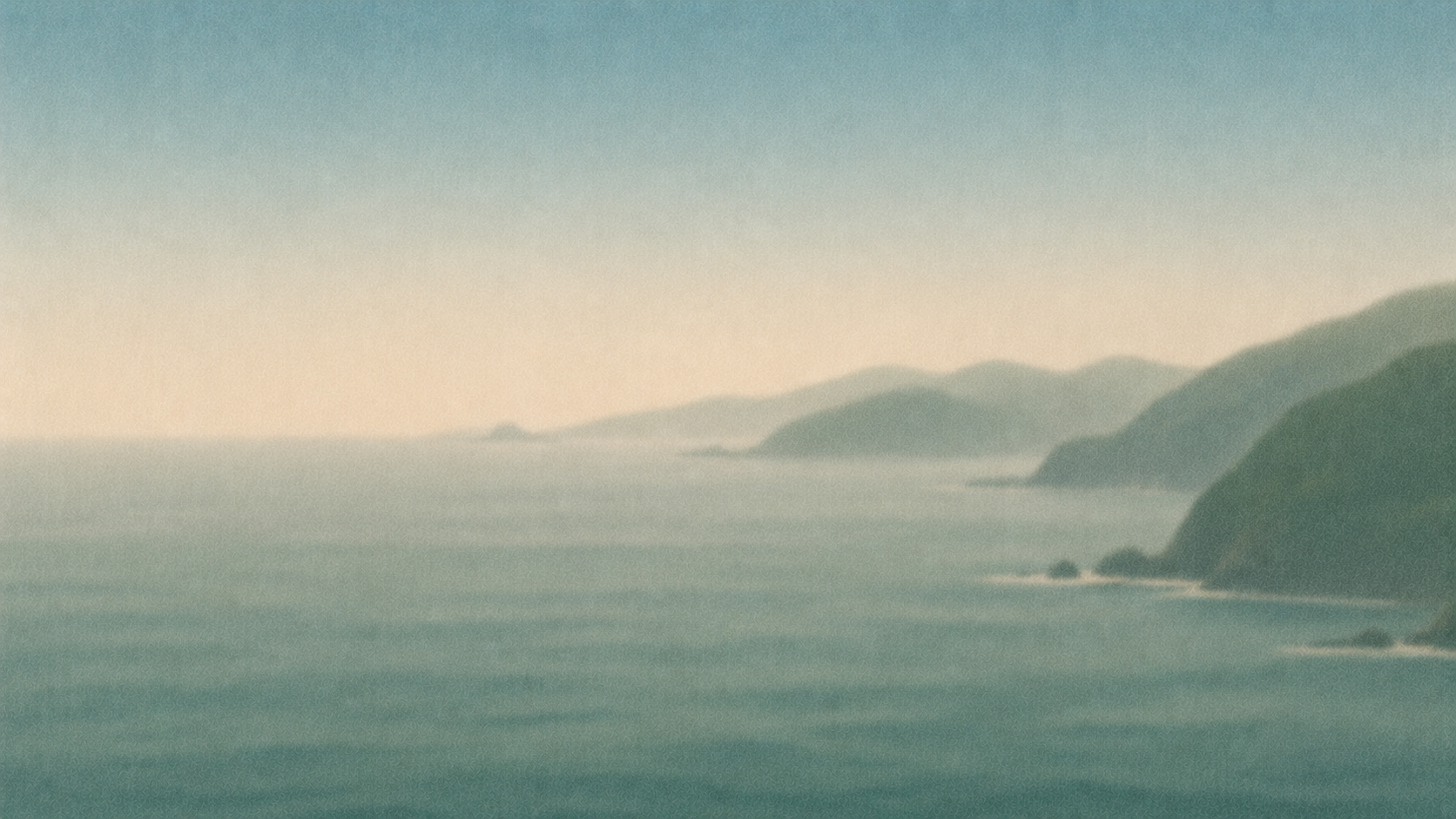 A coastal landscape with mountains in the distance and calm ocean waters in the foreground. The sky is light, possibly during sunrise or sunset.