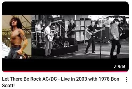 A black and white video thumbnail shows a band performing live on stage, with several musicians playing guitars and drums, and a woman posing confidently in a separate color inset on the left.
