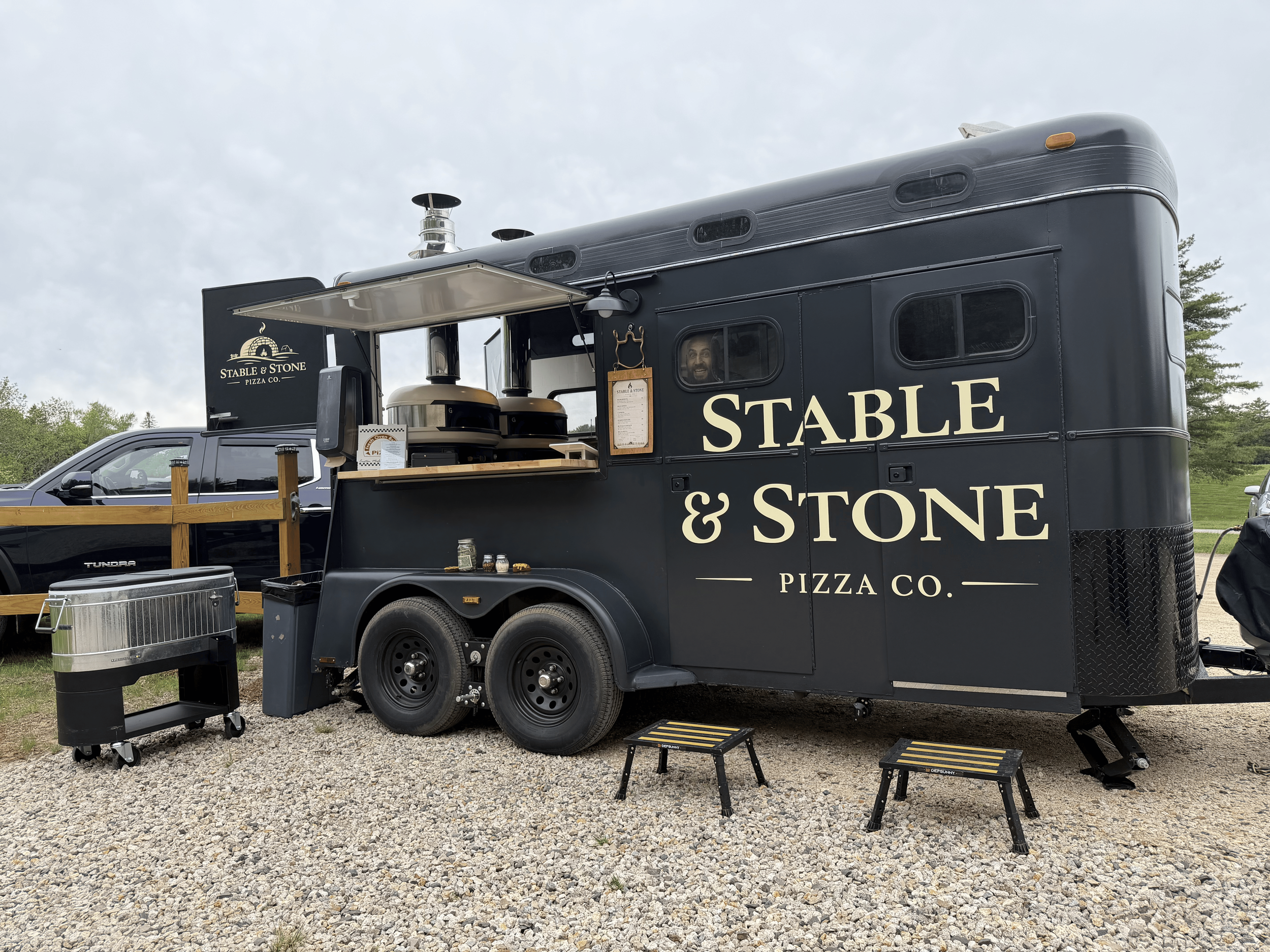 A black food truck with the name