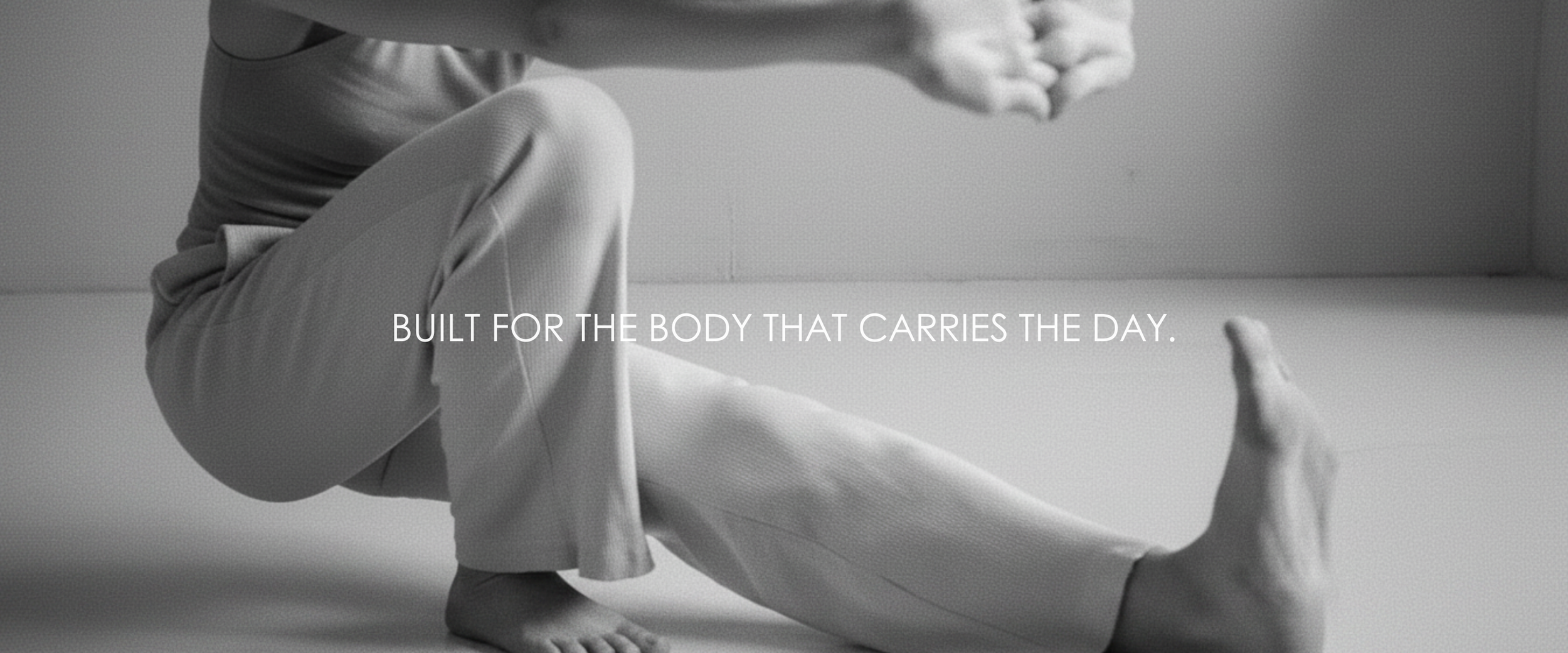 A person practicing yoga or stretching, with a quote overlay that reads 'Built for the body that carries the day.'