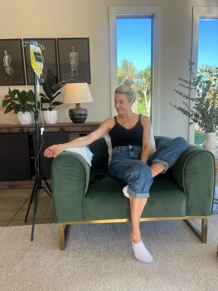 Client relaxing at home while receiving a mobile IV infusion treatment in a comfortable setting.