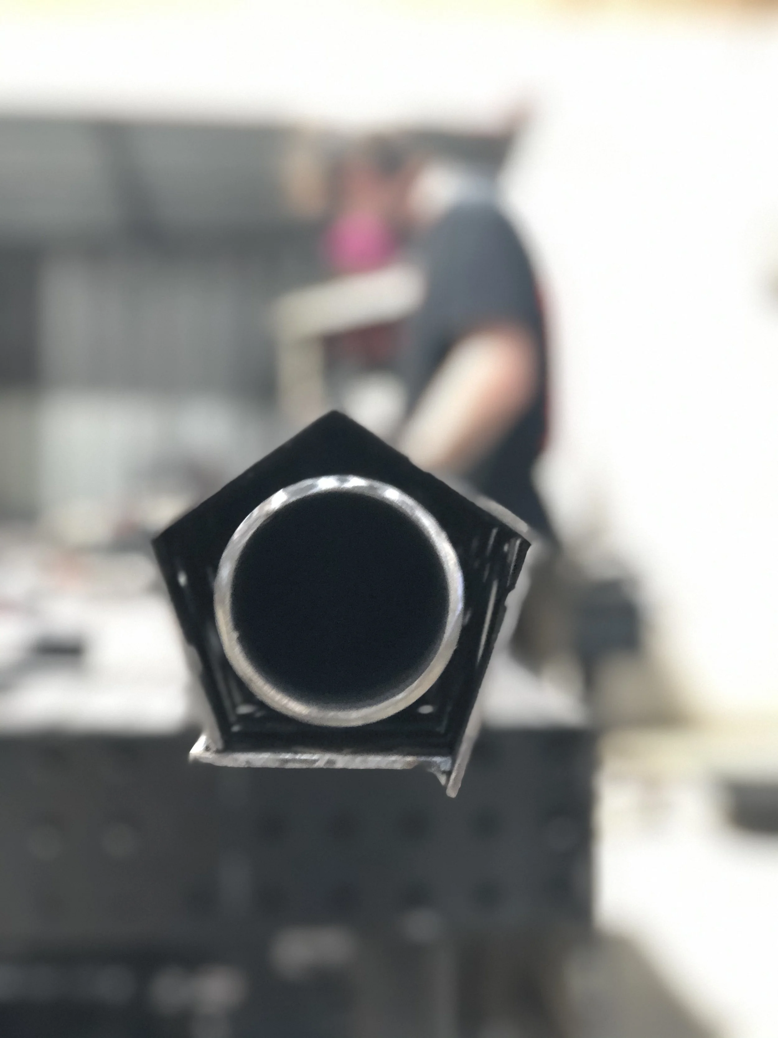 Close-up of a black firearm barrel pointing directly at the camera.