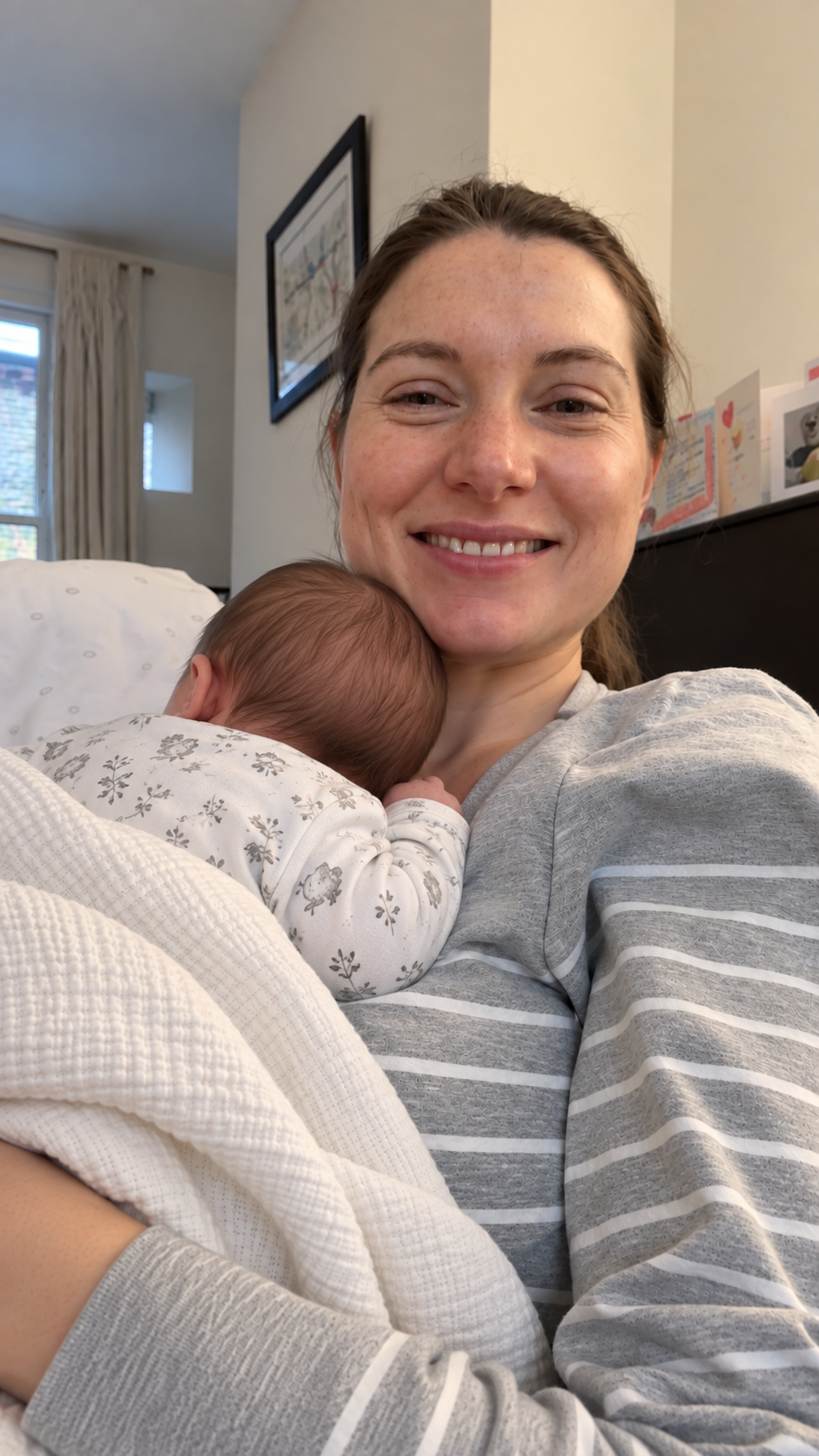 Jess Green cuddling her newborn daughter at home