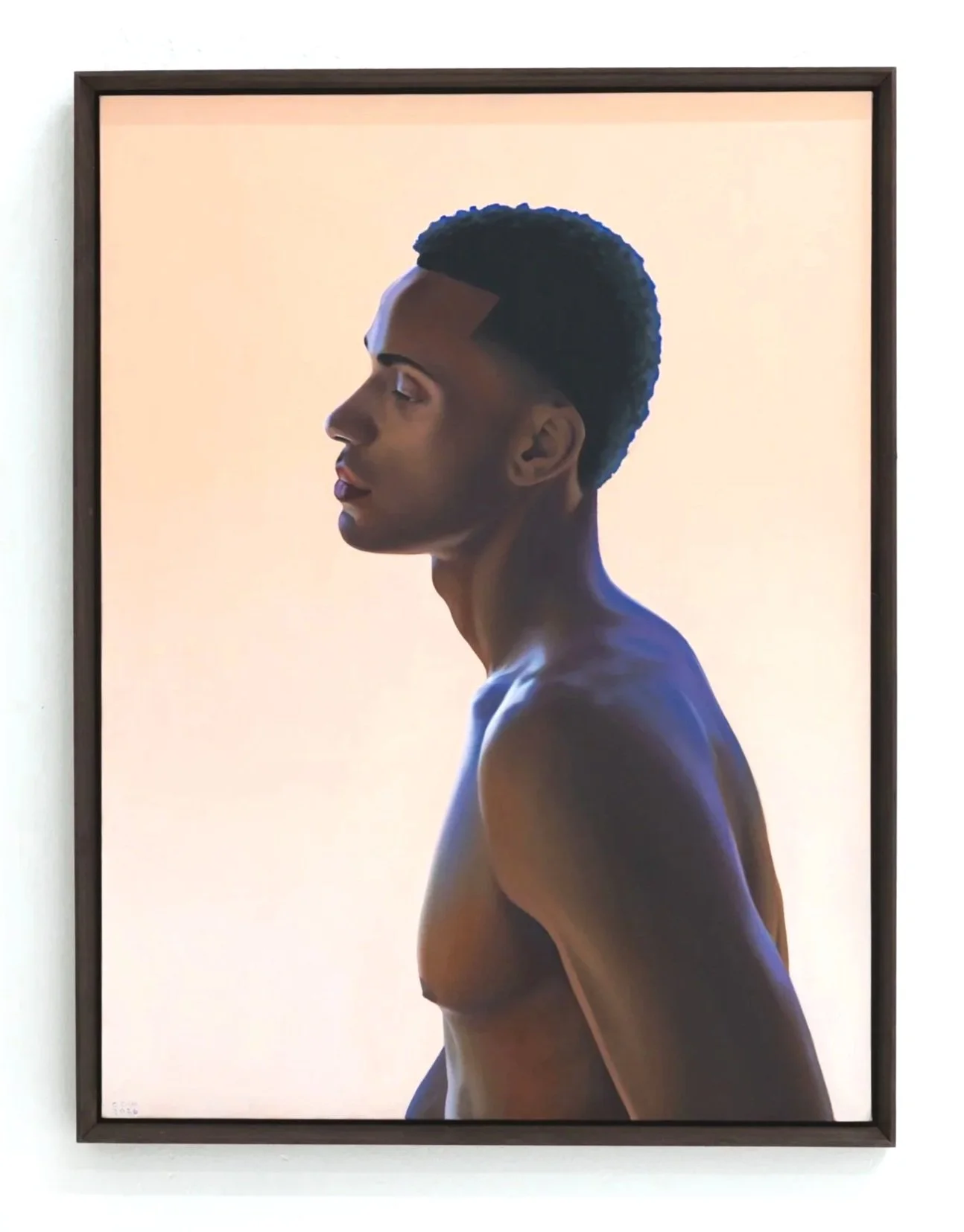 A portrait photograph of a person with dark skin in profile, showing the face and upper body, with their head slightly tilted back, against a plain, soft pastel background.