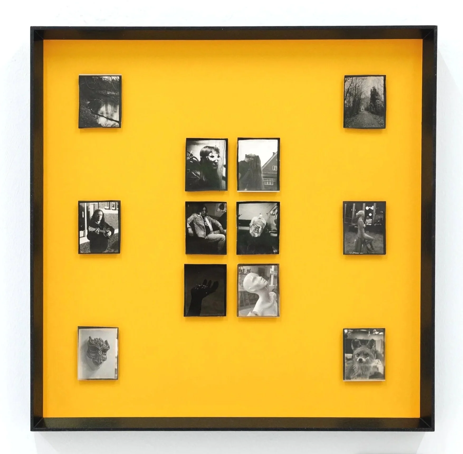 A framed art piece titled 'Culture & Citizenship' by Nikolai Nielsen from Copenhagen, 2022, features series of black and white positive prints. The prints include landscapes, portraits, and artistic representations, with some images showing people, a