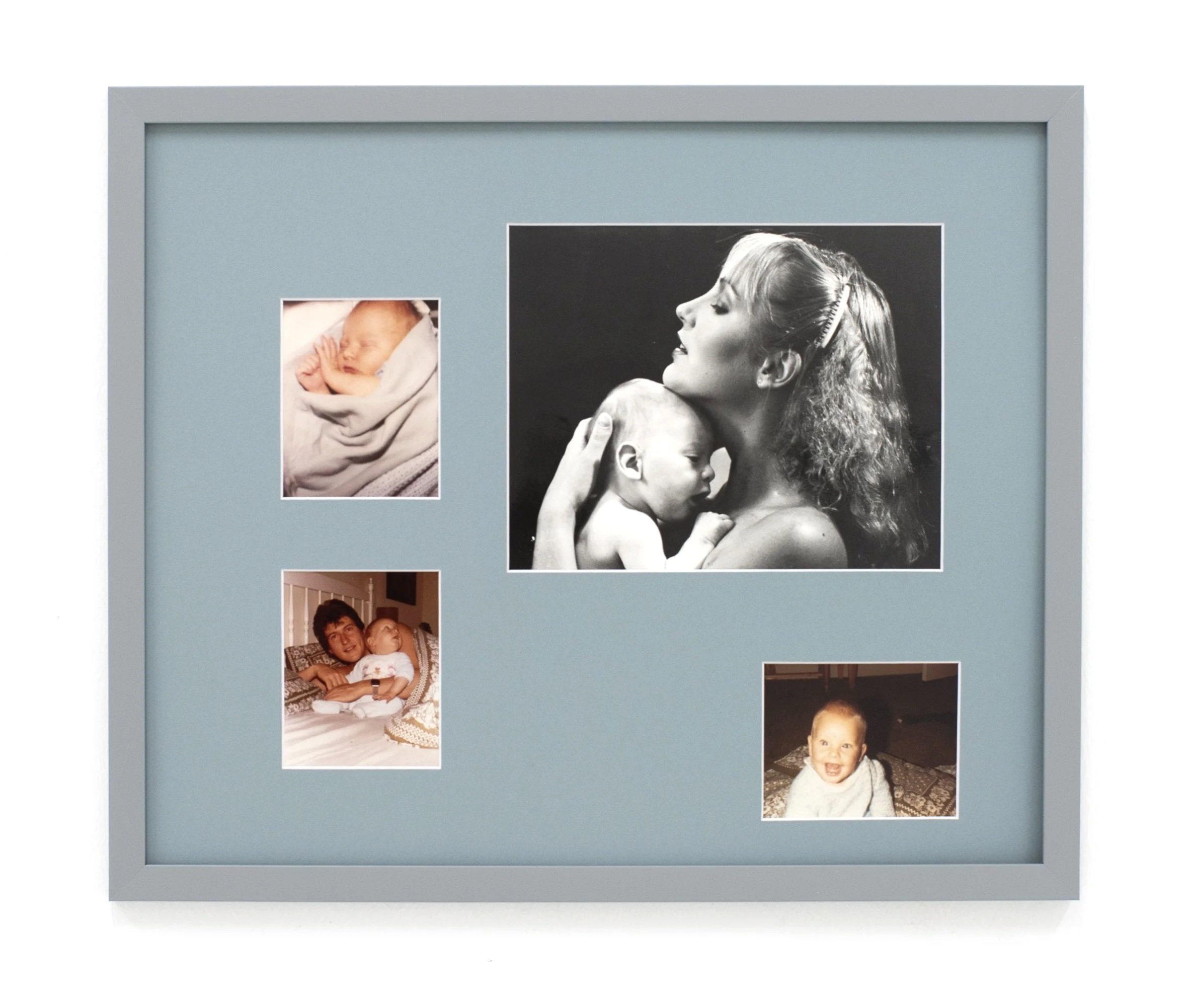 A collection of photos on a light gray display board, including images of a sleeping baby, a woman with curly hair hugging a boy, and a toddler with a big smile.