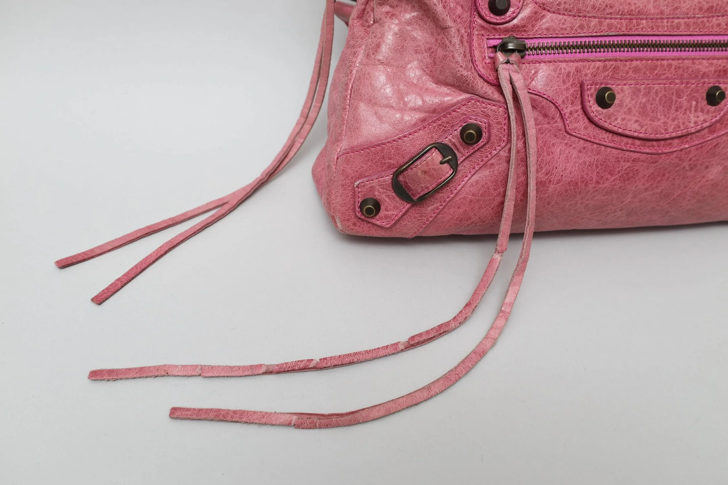 magenta distressed leather bag detail