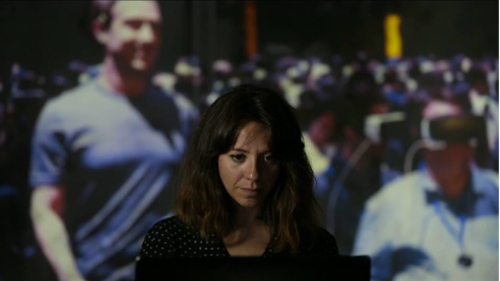 gema fernandez blanco martin with shoulder-length brown hair looking down with a crowd of people in the background. working with robots and virtual reality